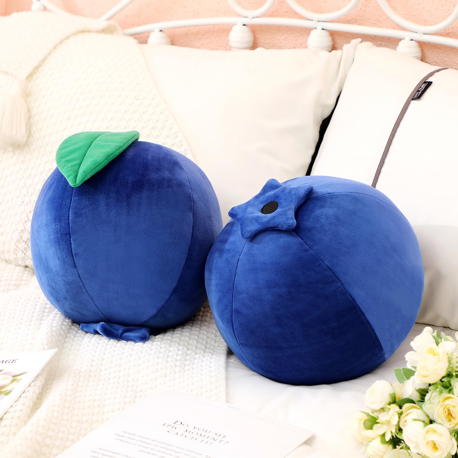 Beeveer blueberry plush pillow in a cozy bedroom setup.