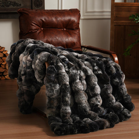 BENVWE fluffy faux fur throw blanket on couch with 3D bubble texture for cozy warmth.
