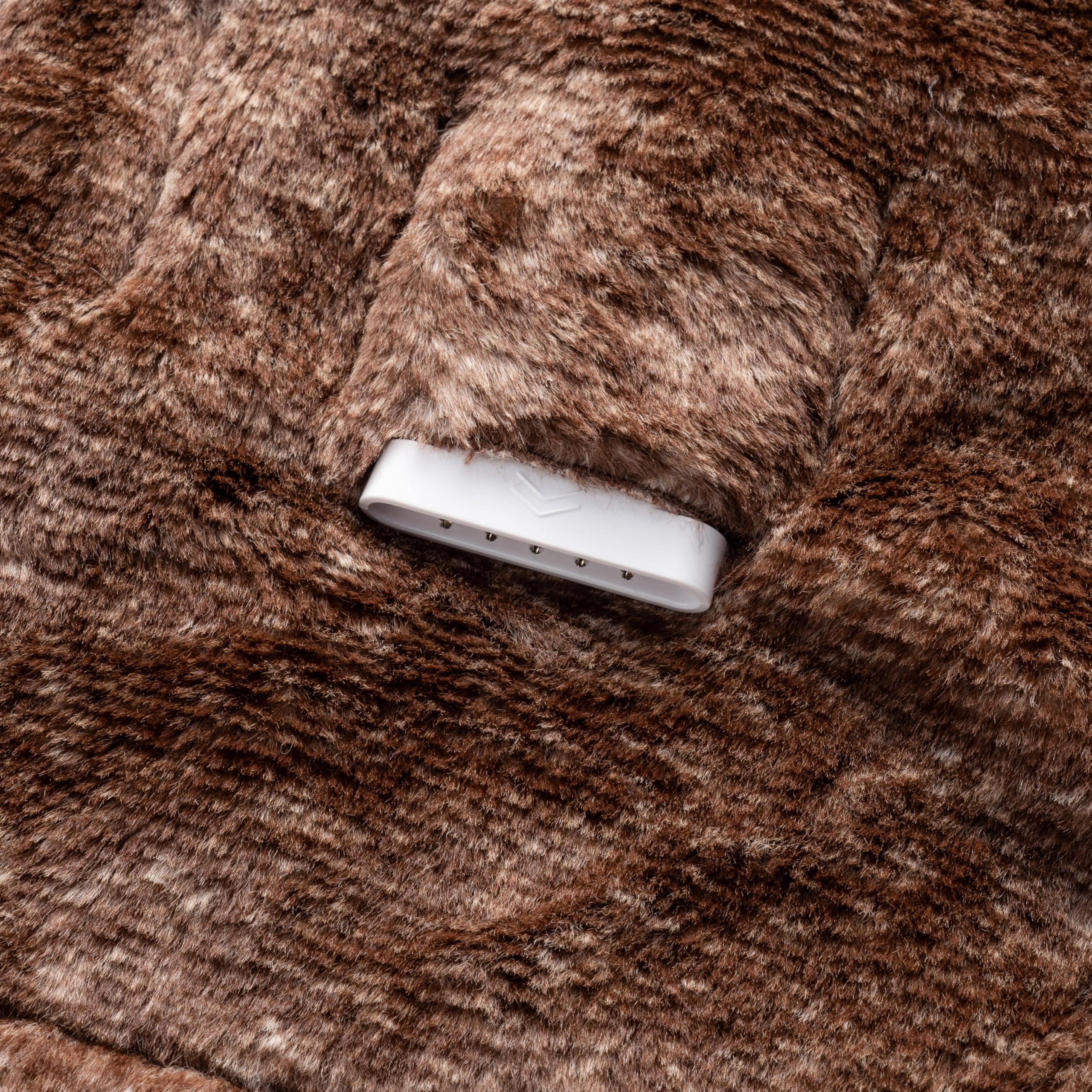 Berkshire Blanket cozy throw laid across bed for lounging.