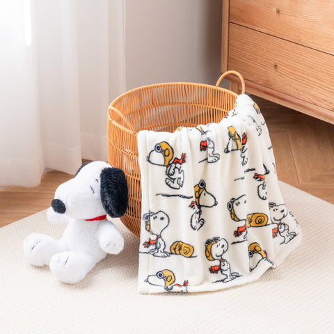 Berkshire Blanket Peanuts cozy living room setup with Snoopy plush throw