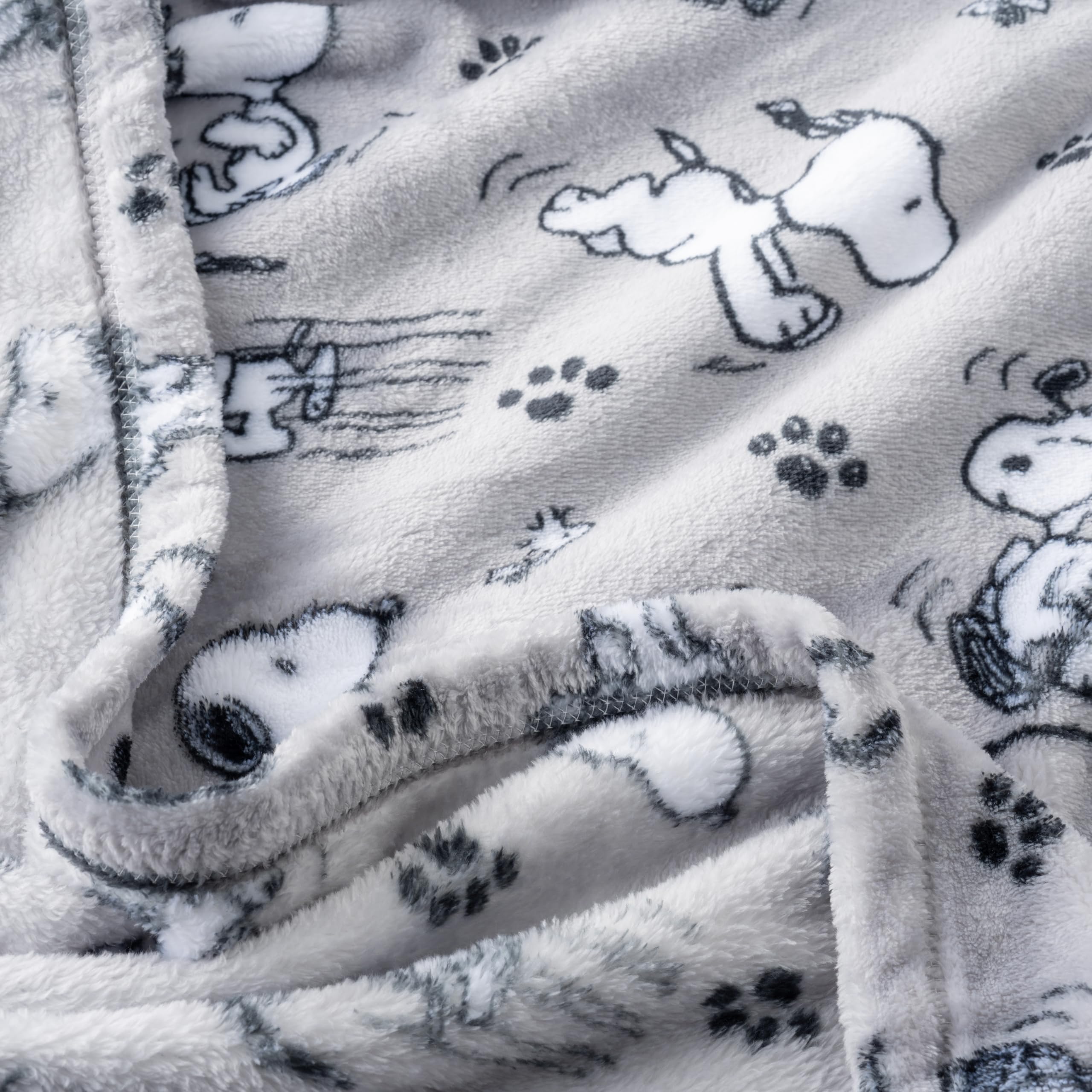 Berkshire Blanket Peanuts grey VelvetLoft weave highlights soft, breathable warmth for lounging.