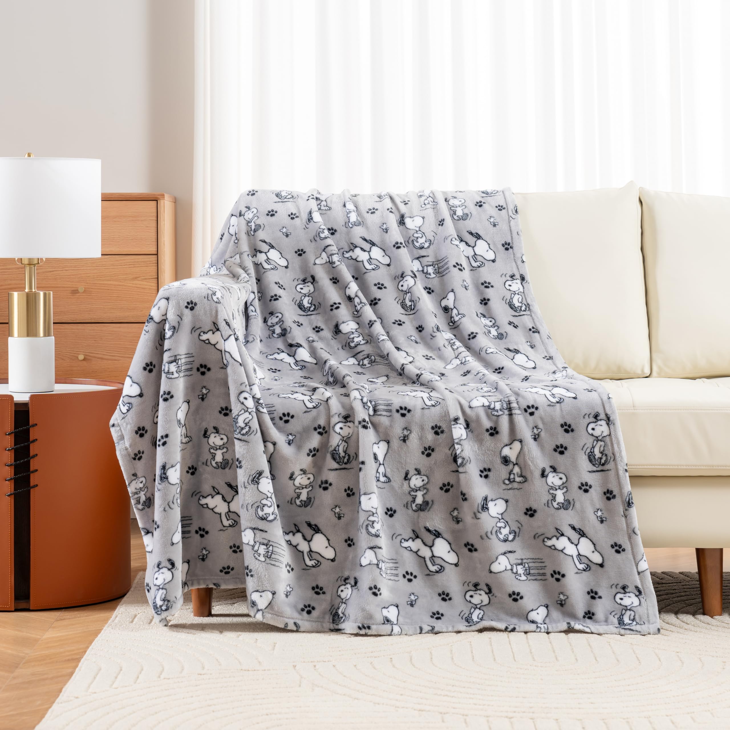 Berkshire Blanket Peanuts cute character Snoopy face throw highlights inviting year round comfort.
