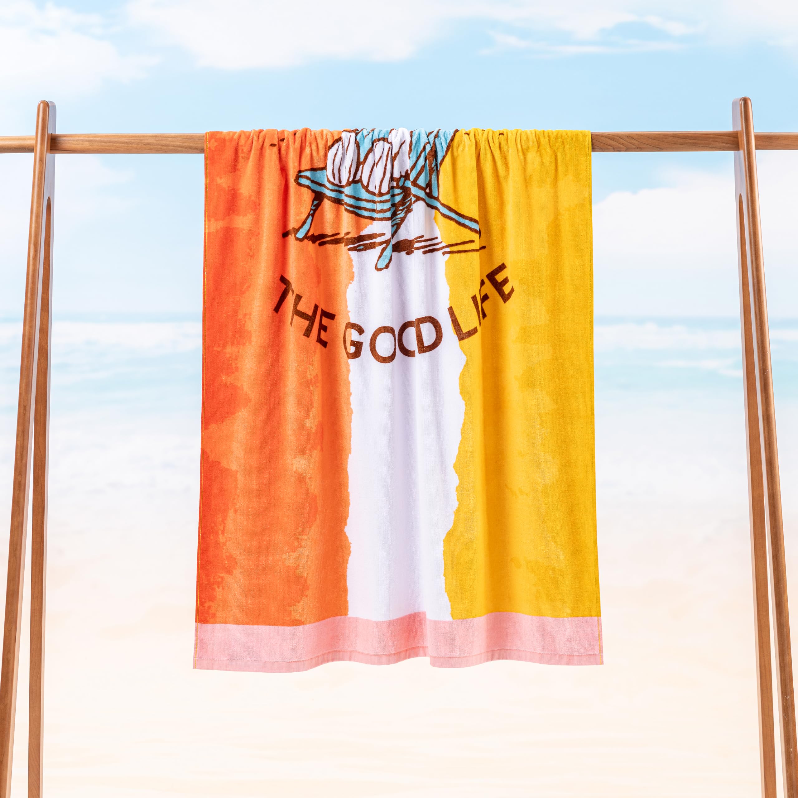 Berkshire Blanket Snoopy towel spread for sunbathing and family fun on sandy beach.