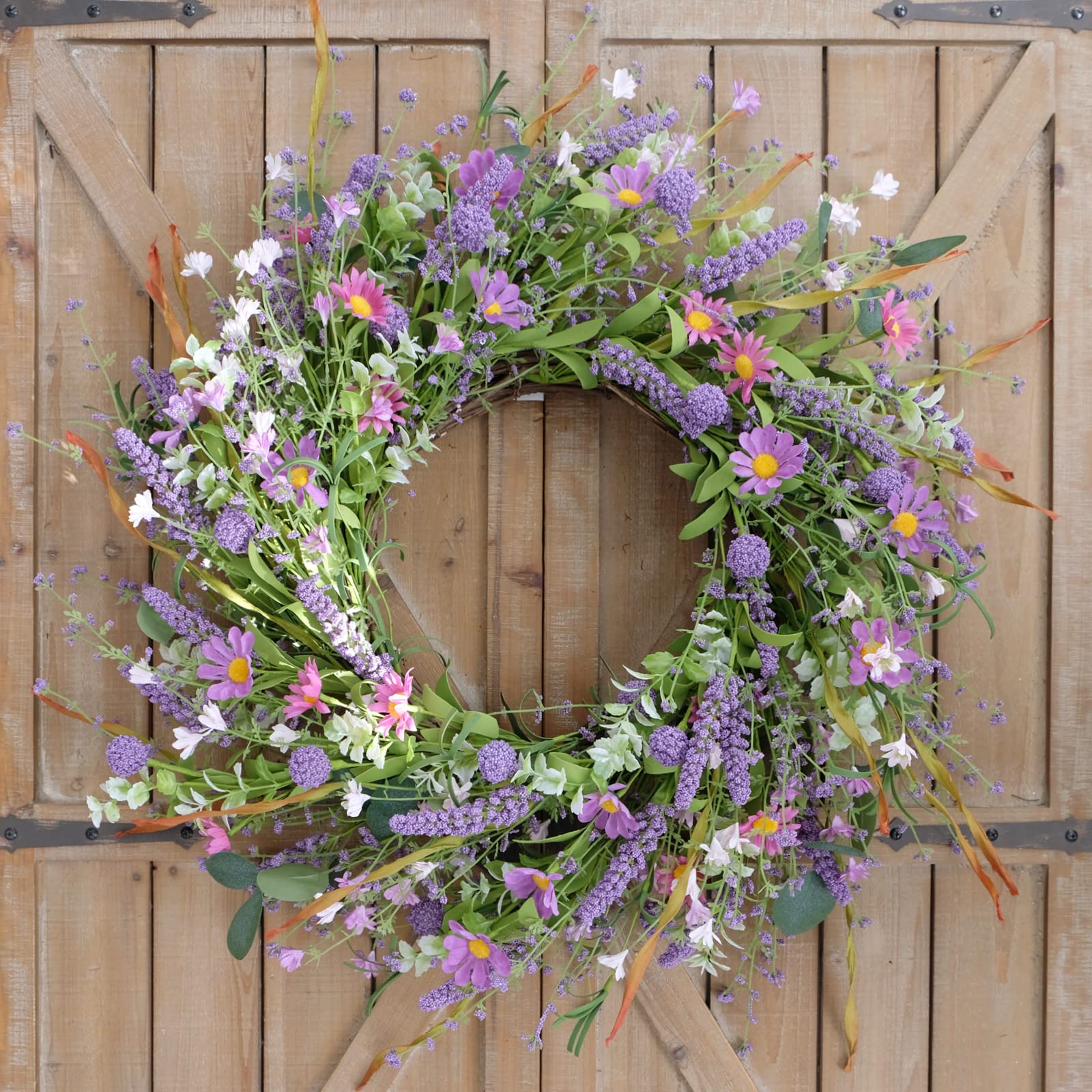 Bibelot spring/summer wreath features pink-purple blooms and green leaves for indoor or outdoor use.