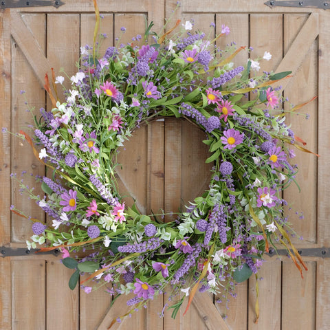 Bibelot spring/summer wreath features pink-purple blooms and green leaves for indoor or outdoor use.