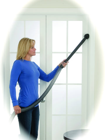 Bissell BigGreen PowerForce extension wand reaching tight corners for thorough edge cleaning.
