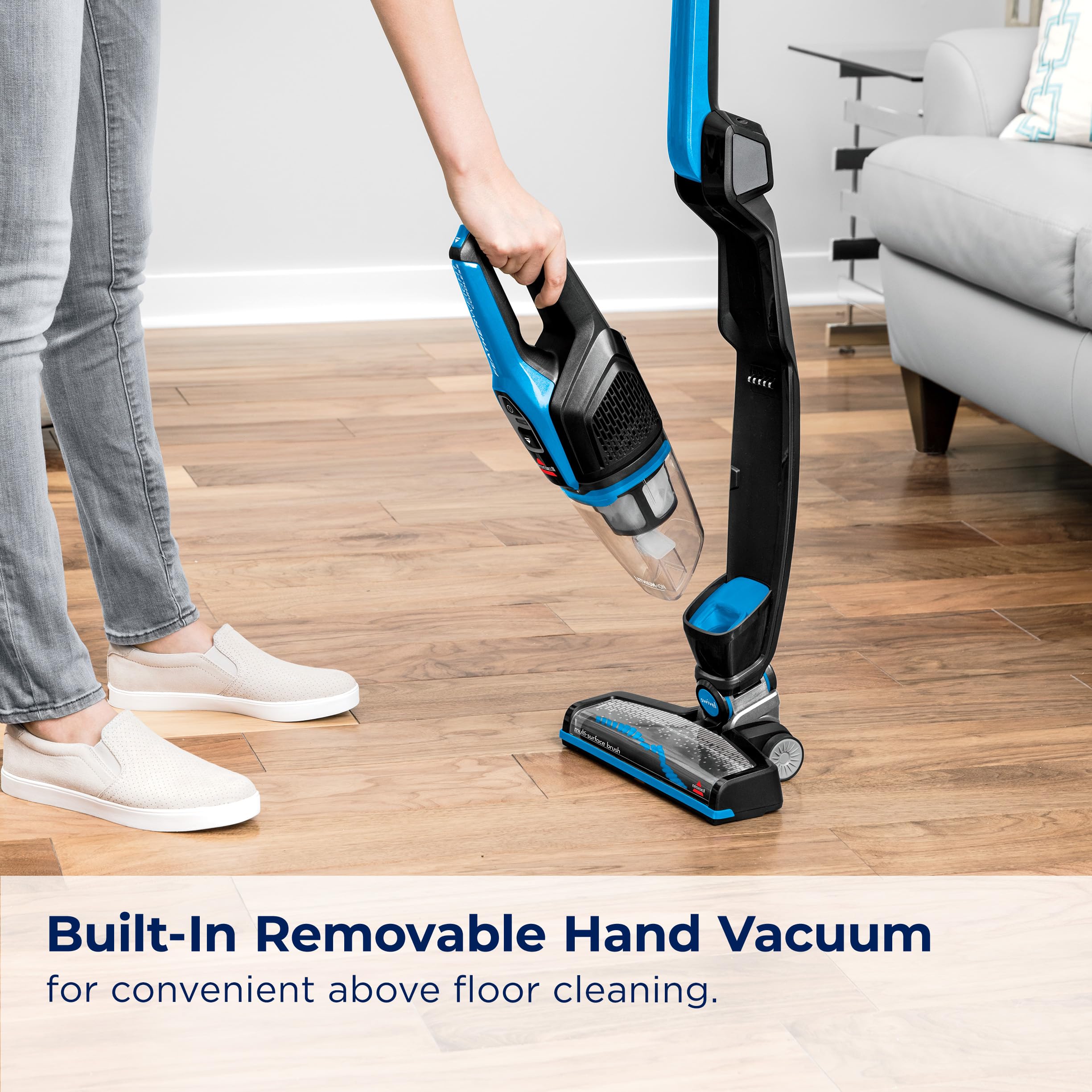 Bissell Featherweight cleaning under furniture with extended reach