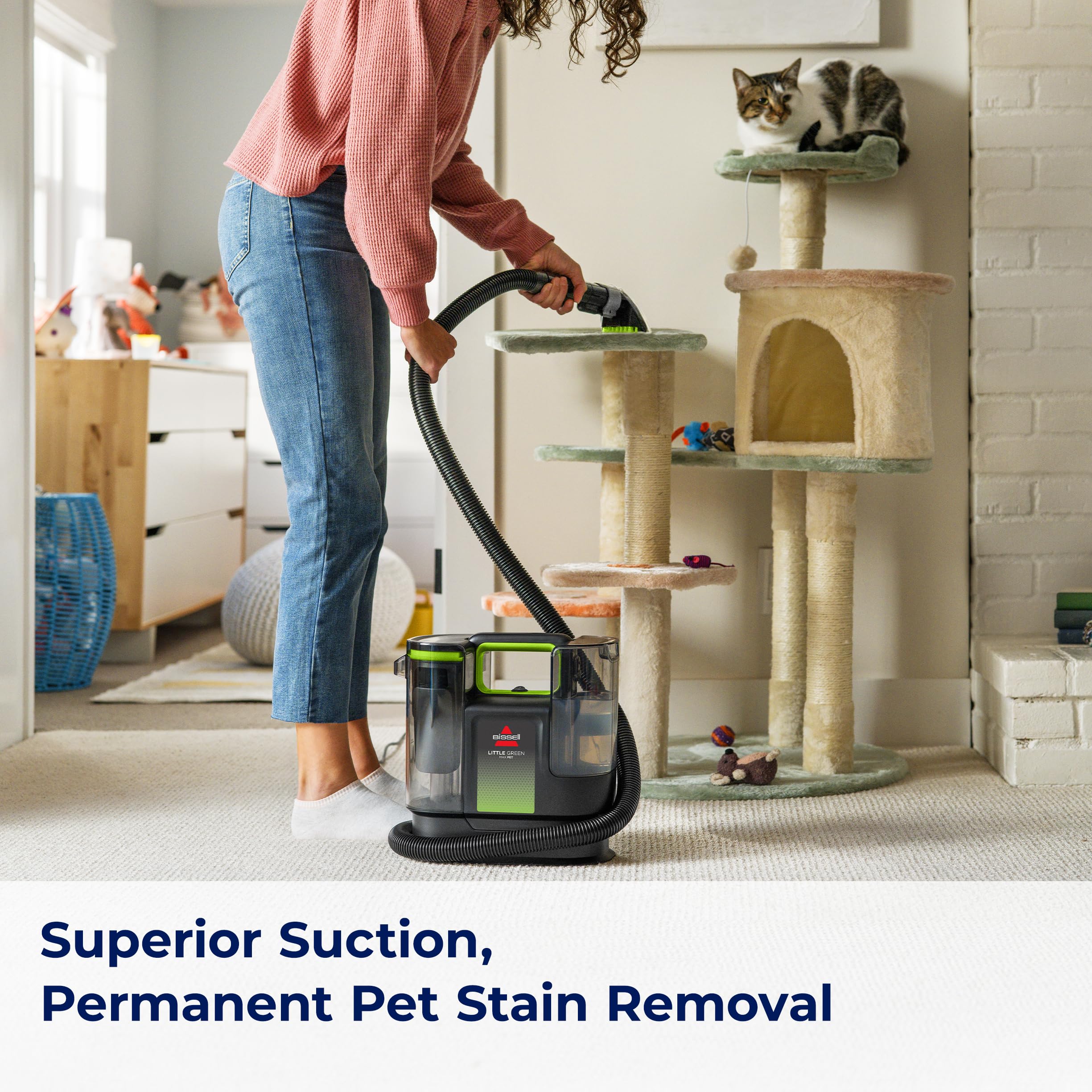 Bissell Little Green Max Pet and Pet Hair Removal Tool on a fabric chair.