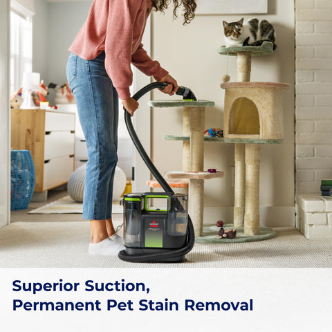 Bissell Little Green Max Pet and Pet Hair Removal Tool on a fabric chair.