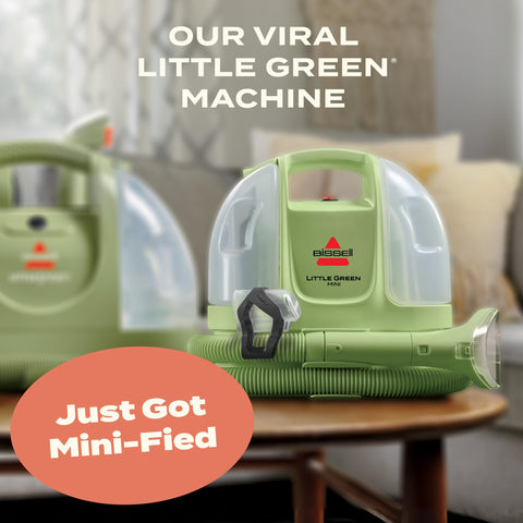 BISSELL Little Green Mini car interior-cleaner-tool in action on upholstery for stains