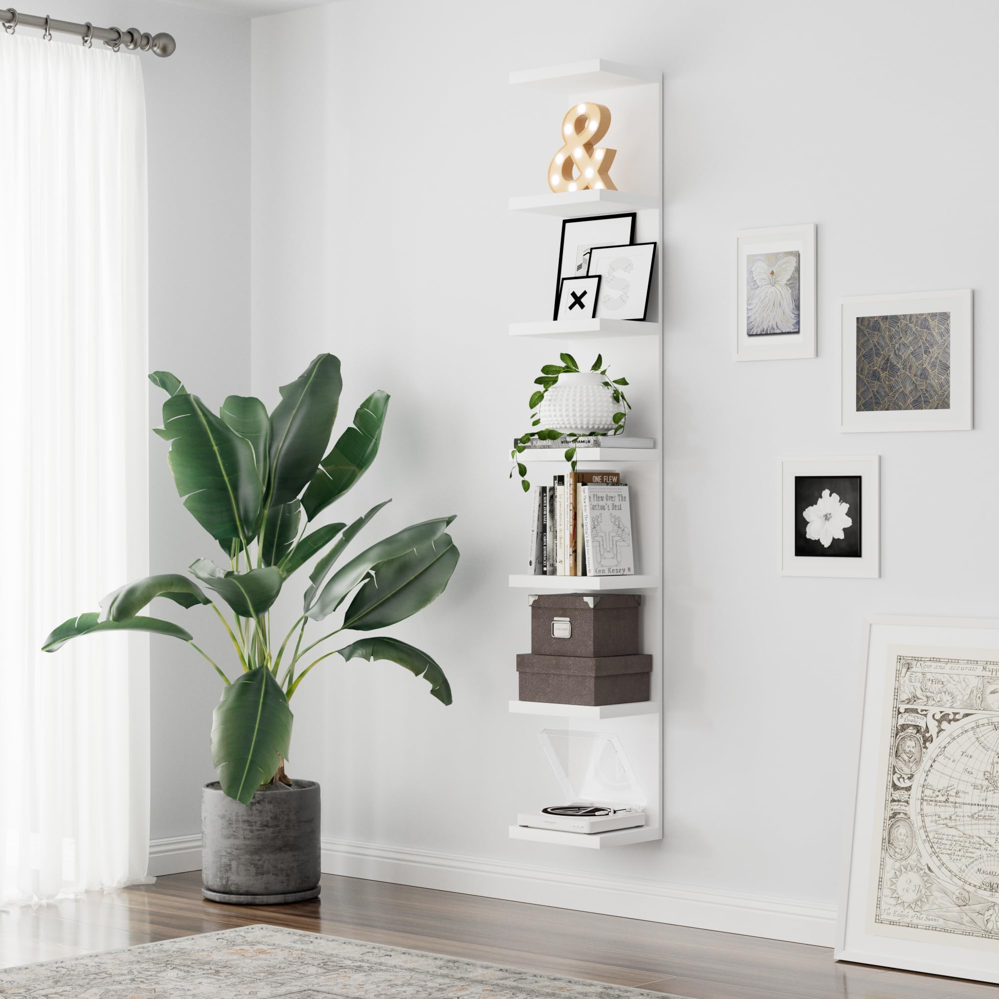 Bkaleme living room setup showcases plants and candles with modern appeal.