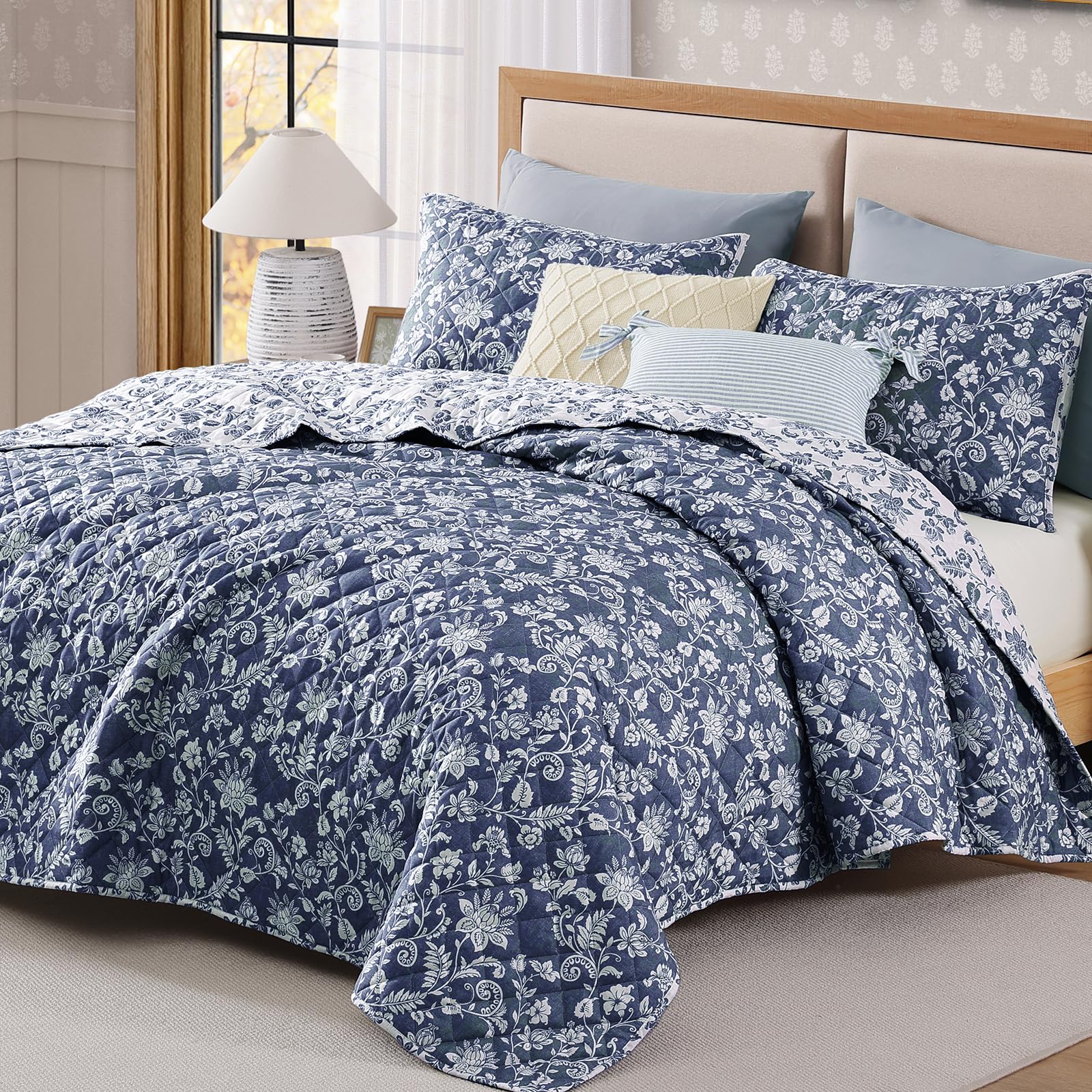BLOOMHAVEN quilt set on bed demonstrates reversible floral design for two looks.