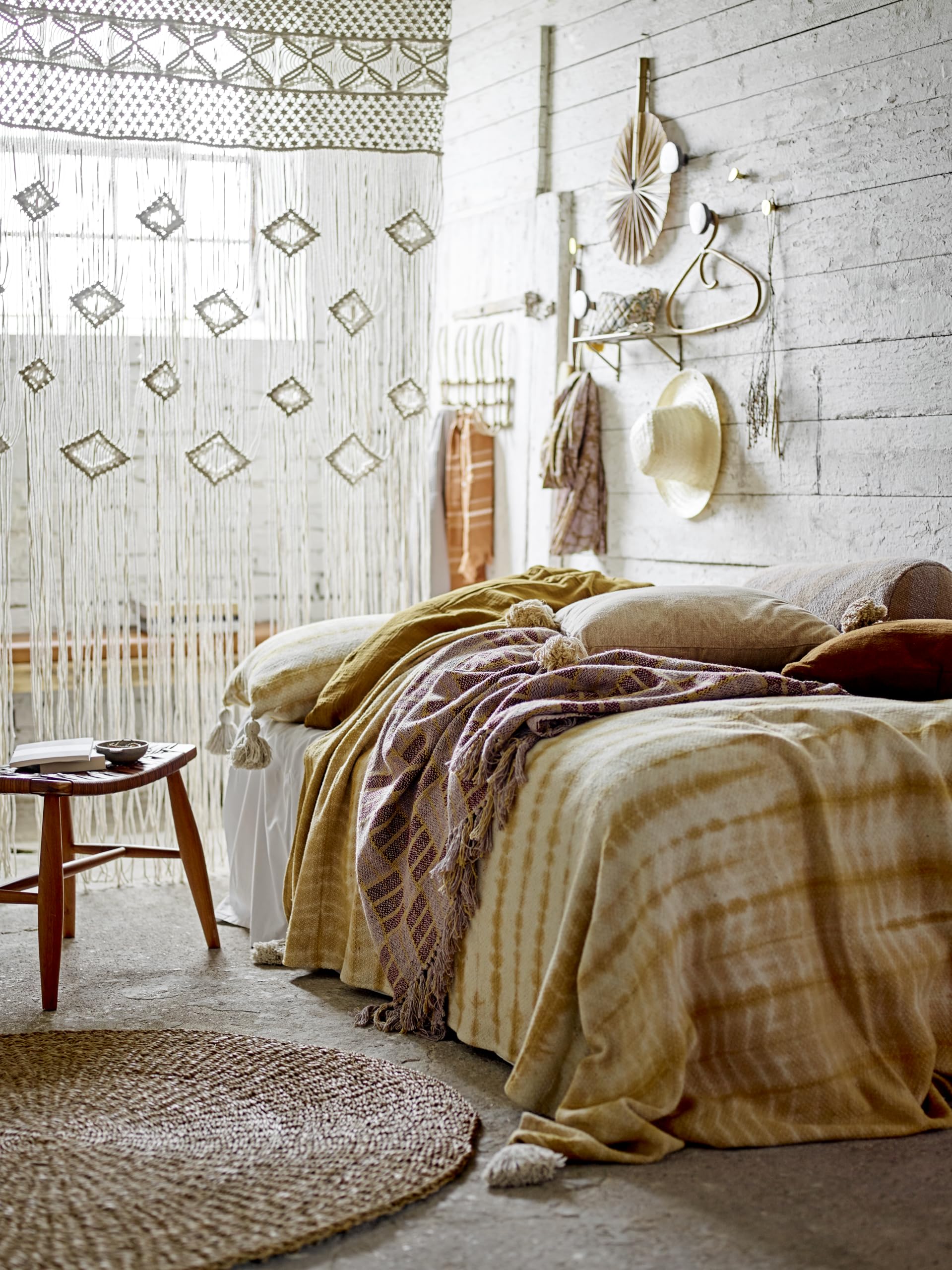 Bloomingville beige rattan wall hanger kitchen-organization keeps towels and robes tidy.
