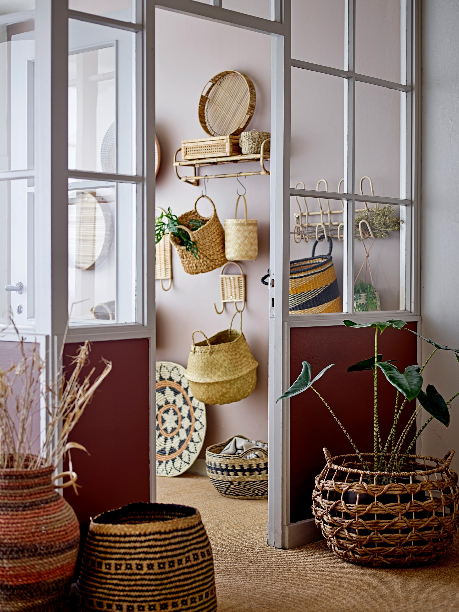 Bloomingville beige rattan wall hanger wall-installation blends with neutral decor.