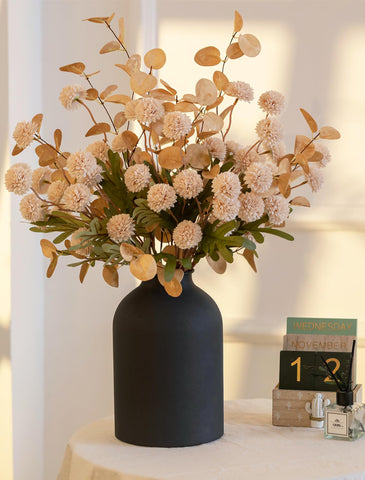 Dining room floral arrangement by BLOSMON creates a refined focal point.