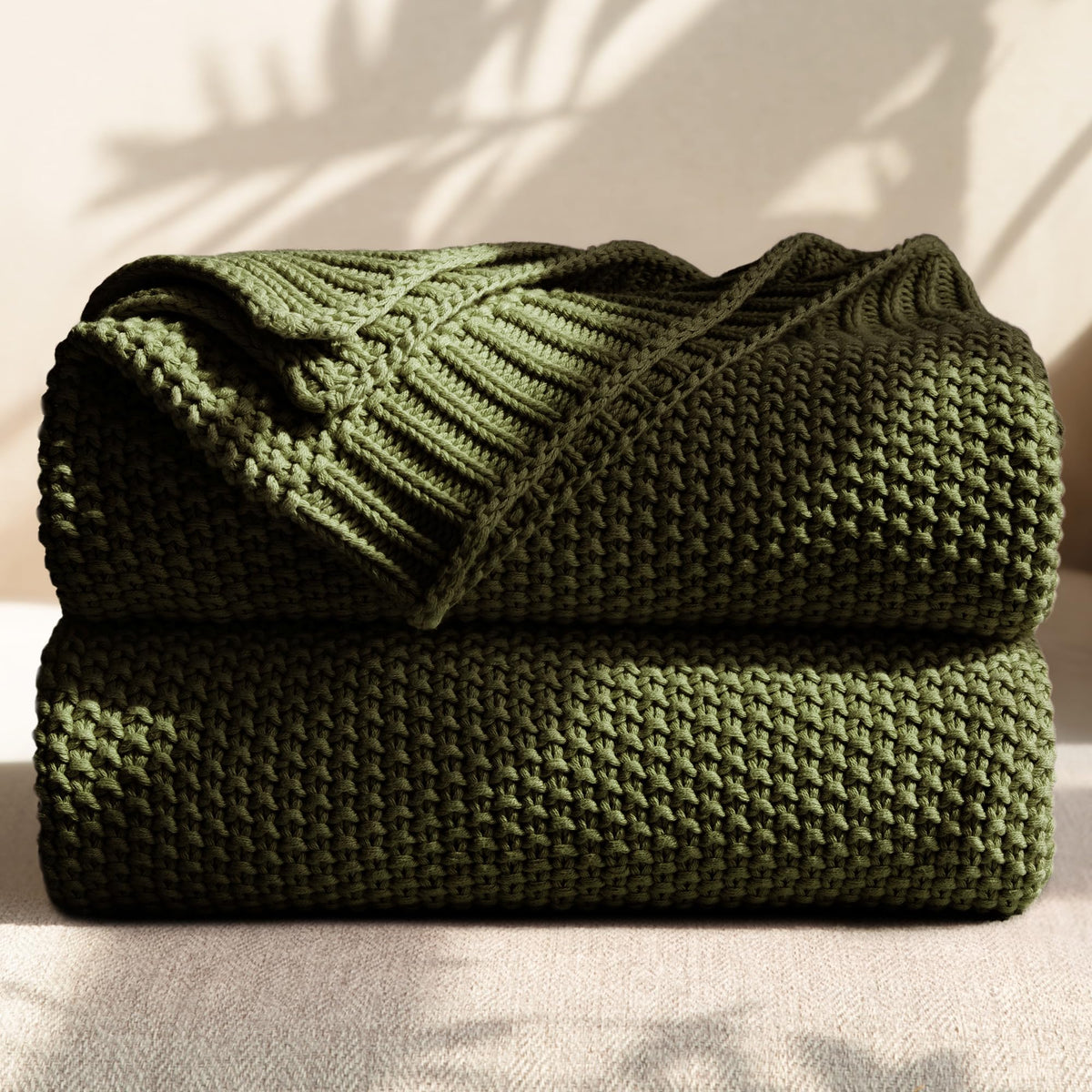 blunique olive-green cotton cable knit throw on sofa for versatile lounging