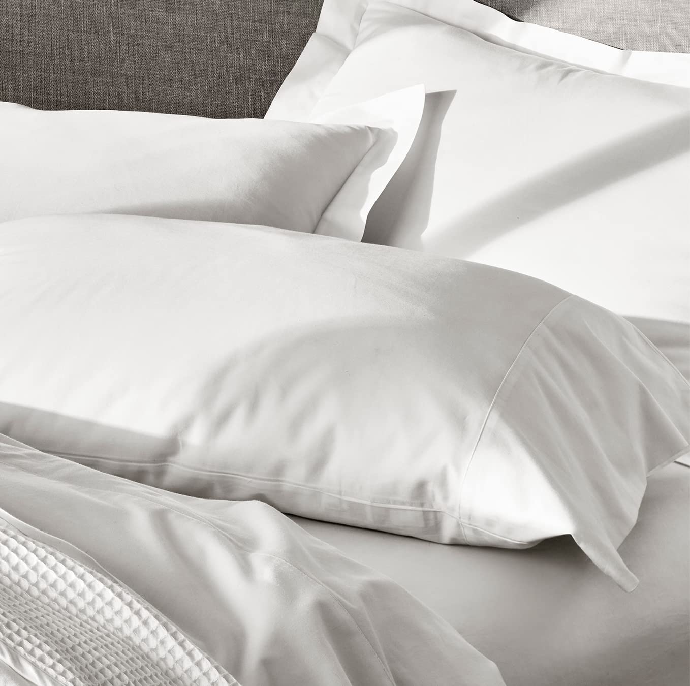 Boll and Branch Butter-soft texture closeup demonstrates luxurious hand feel on bed