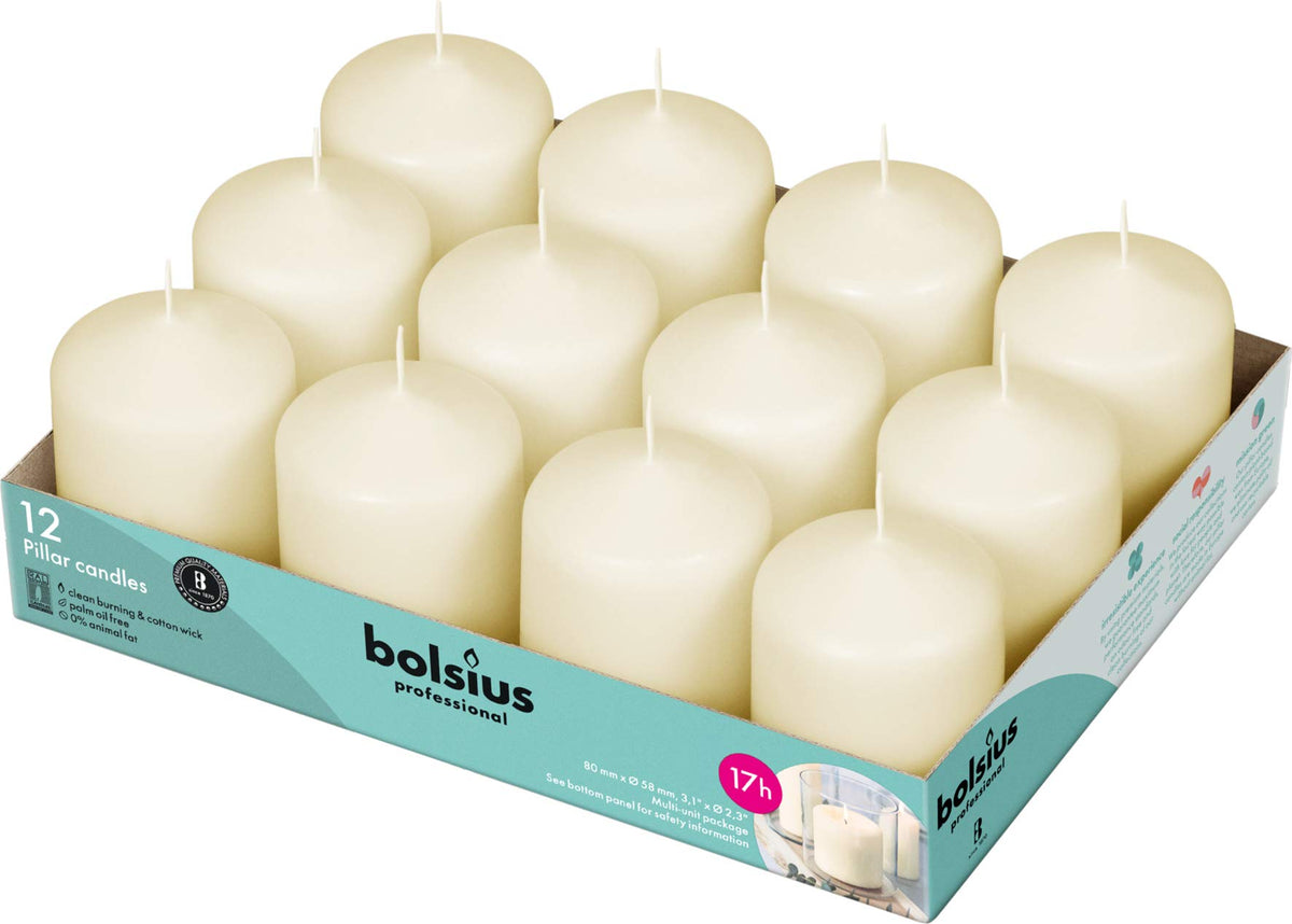 Bolsius Ivory pillar candles on table create an elegant centerpiece with lasting ambiance.