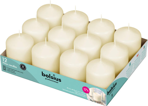 Bolsius Ivory pillar candles on table create an elegant centerpiece with lasting ambiance.