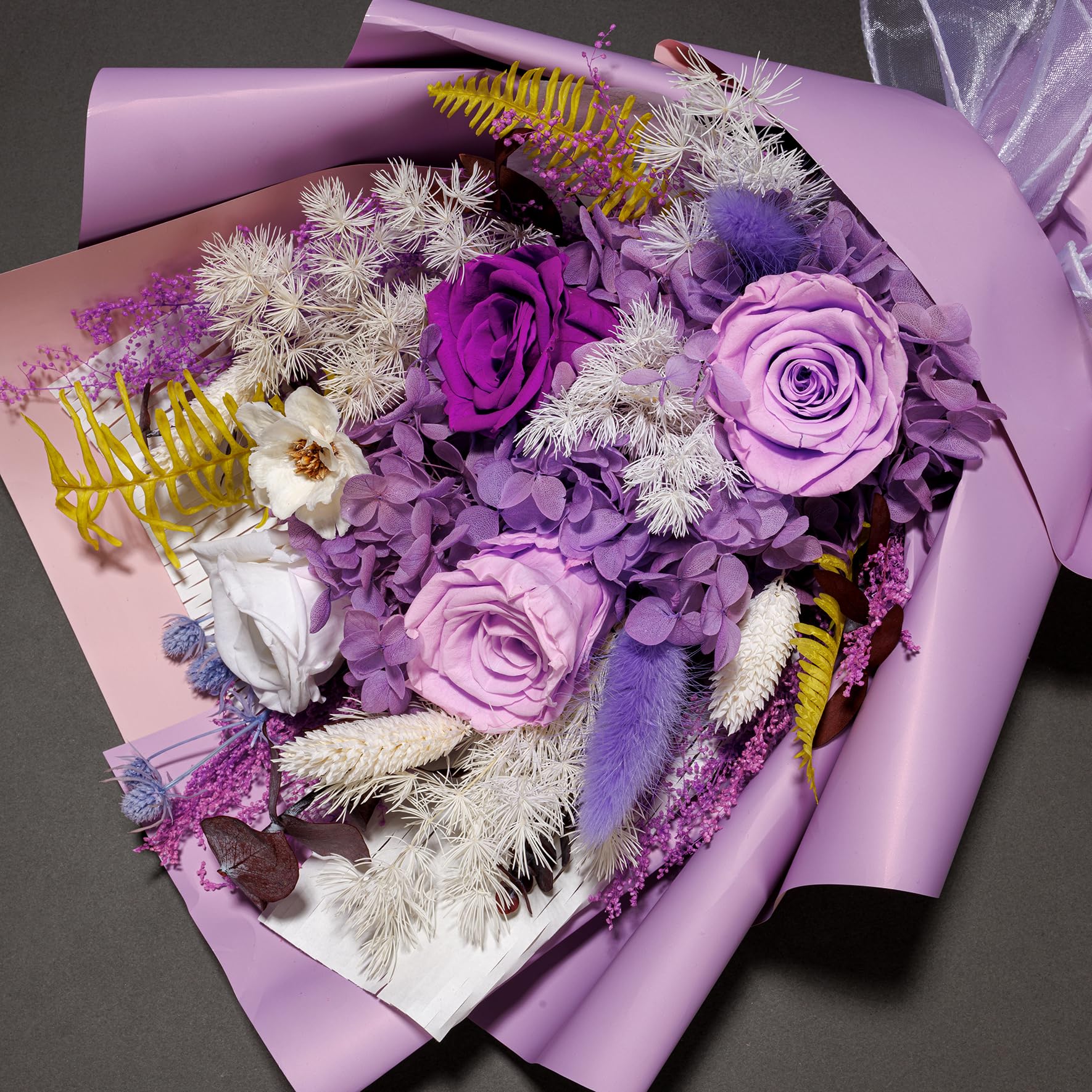 Bonsion preserved flowers in vase, versatile centerpiece for living spaces.