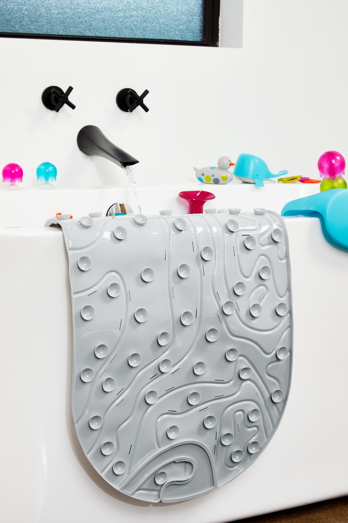 Boon Grifle gray textured mat adds soft grip to tub time.