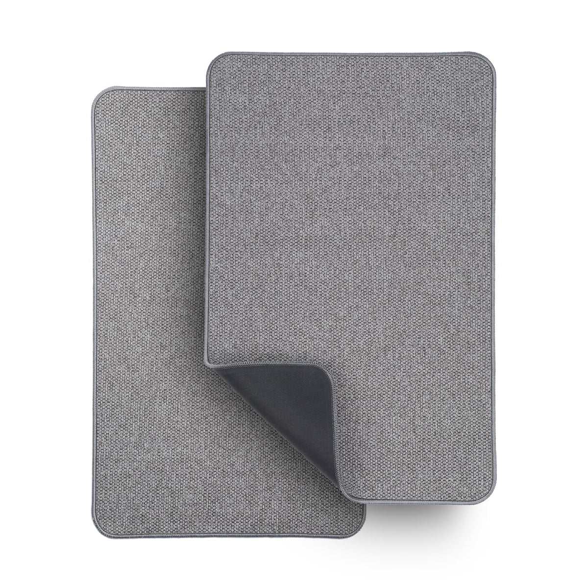 Bosap ultra-thin grey bath mat sits under a door, keeping feet dry.