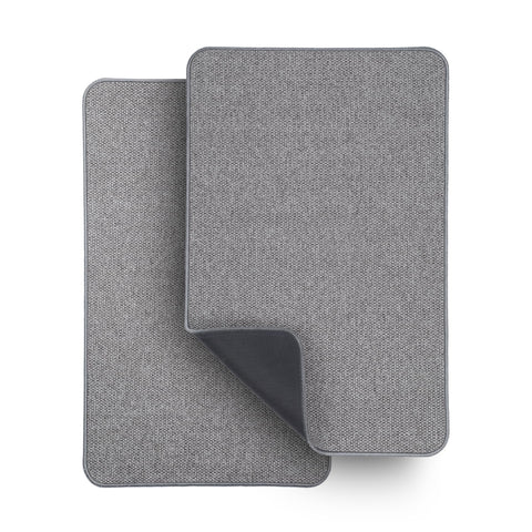 Bosap ultra-thin grey bath mat sits under a door, keeping feet dry.