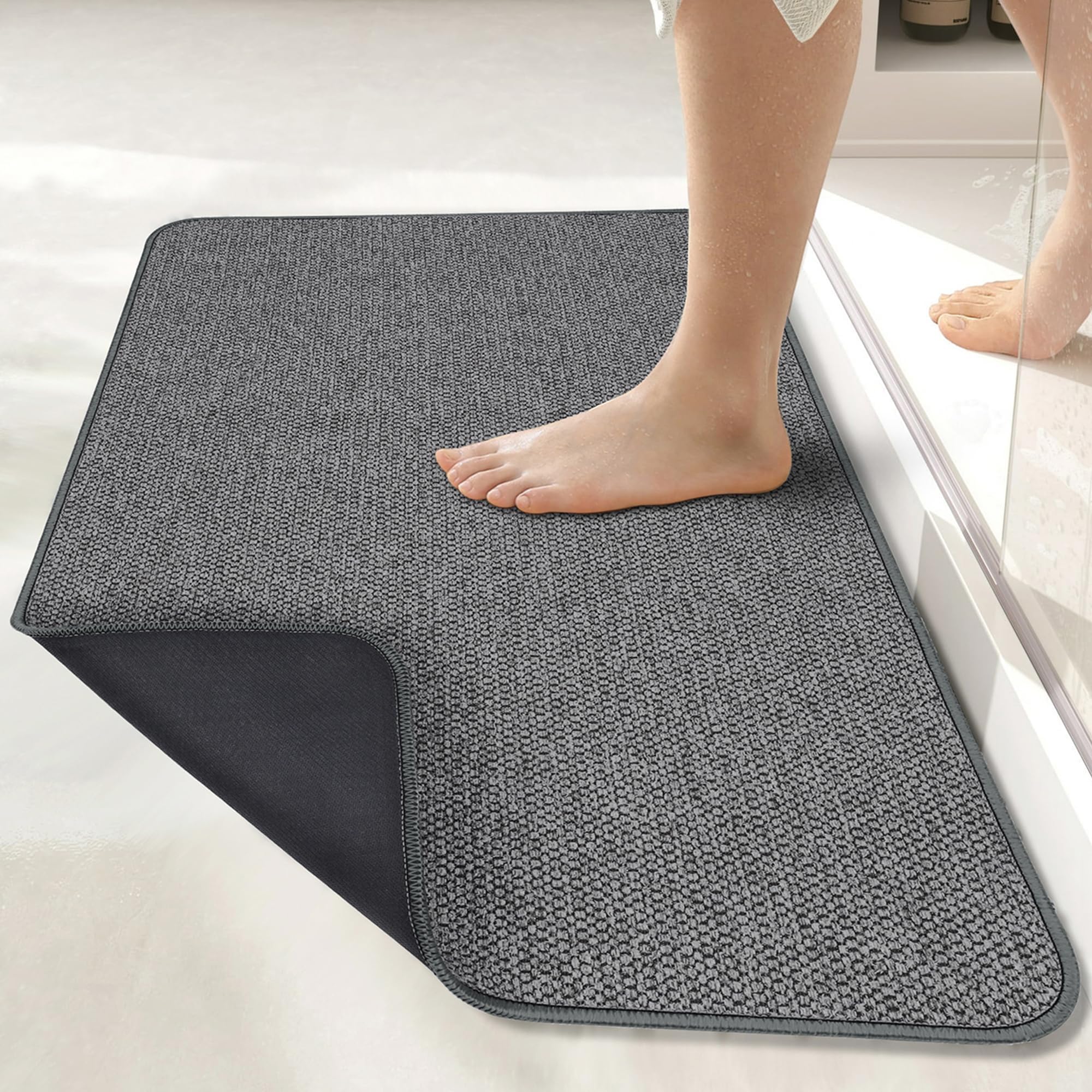 Bosap ultra-thin bath mat under a door showing space-saving design for easy clearance