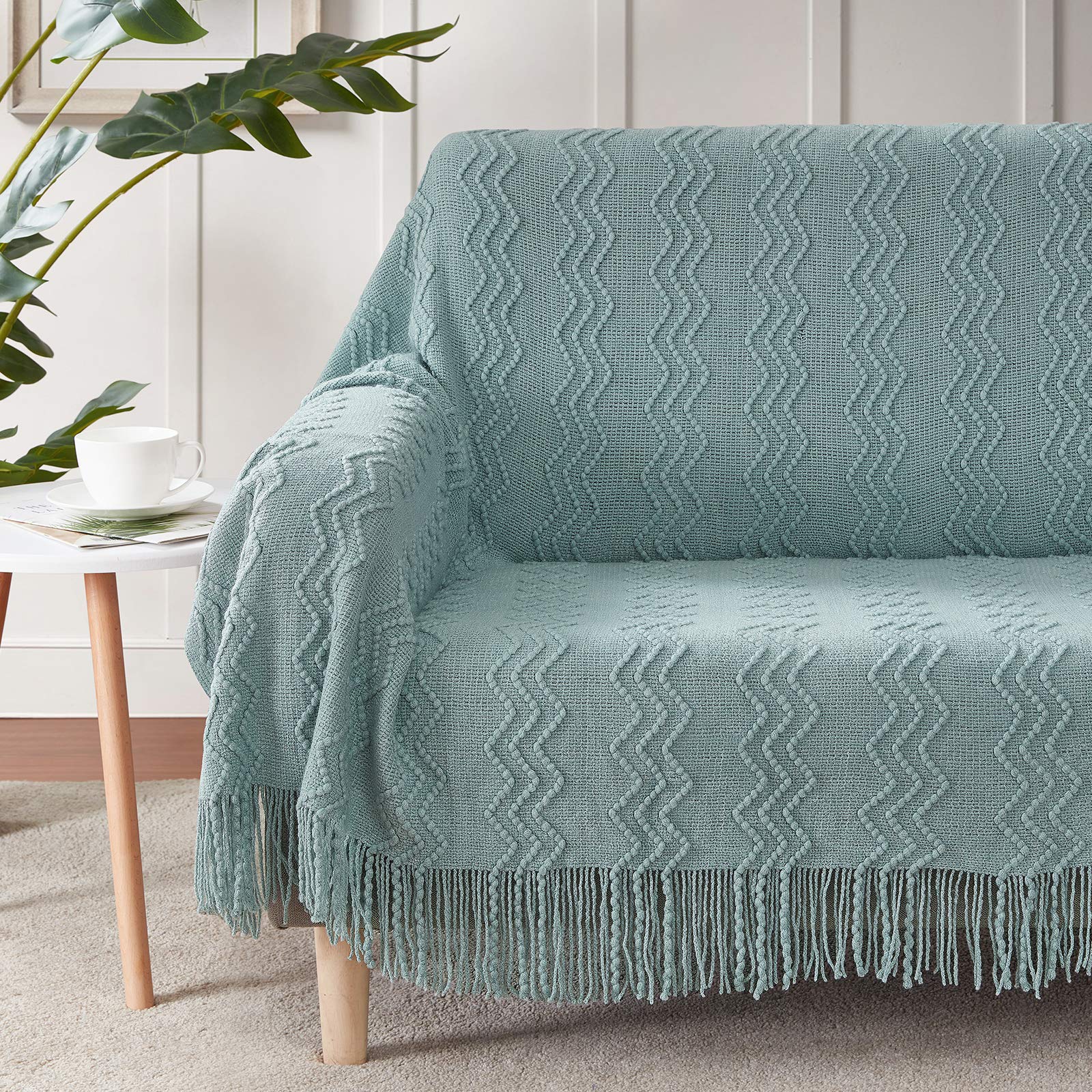 BOURINA Aqua Throw Blanket draped on sofa showcases decorative pattern for stylish living rooms
