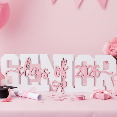 BreezeHug class of 2026 sign with pink font and 3D bow decor as centerpiece