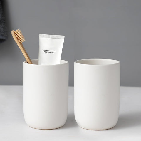BSDISP two-cup white ceramic toothbrush holders arranged on a clean bathroom counter