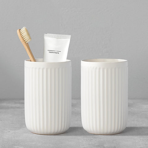 BSDISP white ceramic toothbrush holder with two cups keeps bathroom counter organized.