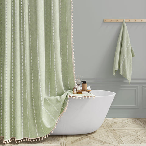 BTTN sage green farmhouse shower curtain with tassel trim enhances luxurious boho bathroom ambiance.