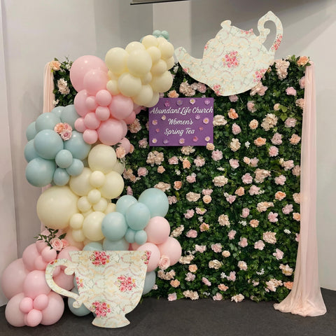 Bucherry teacup arch decor provides a whimsical backdrop for photos