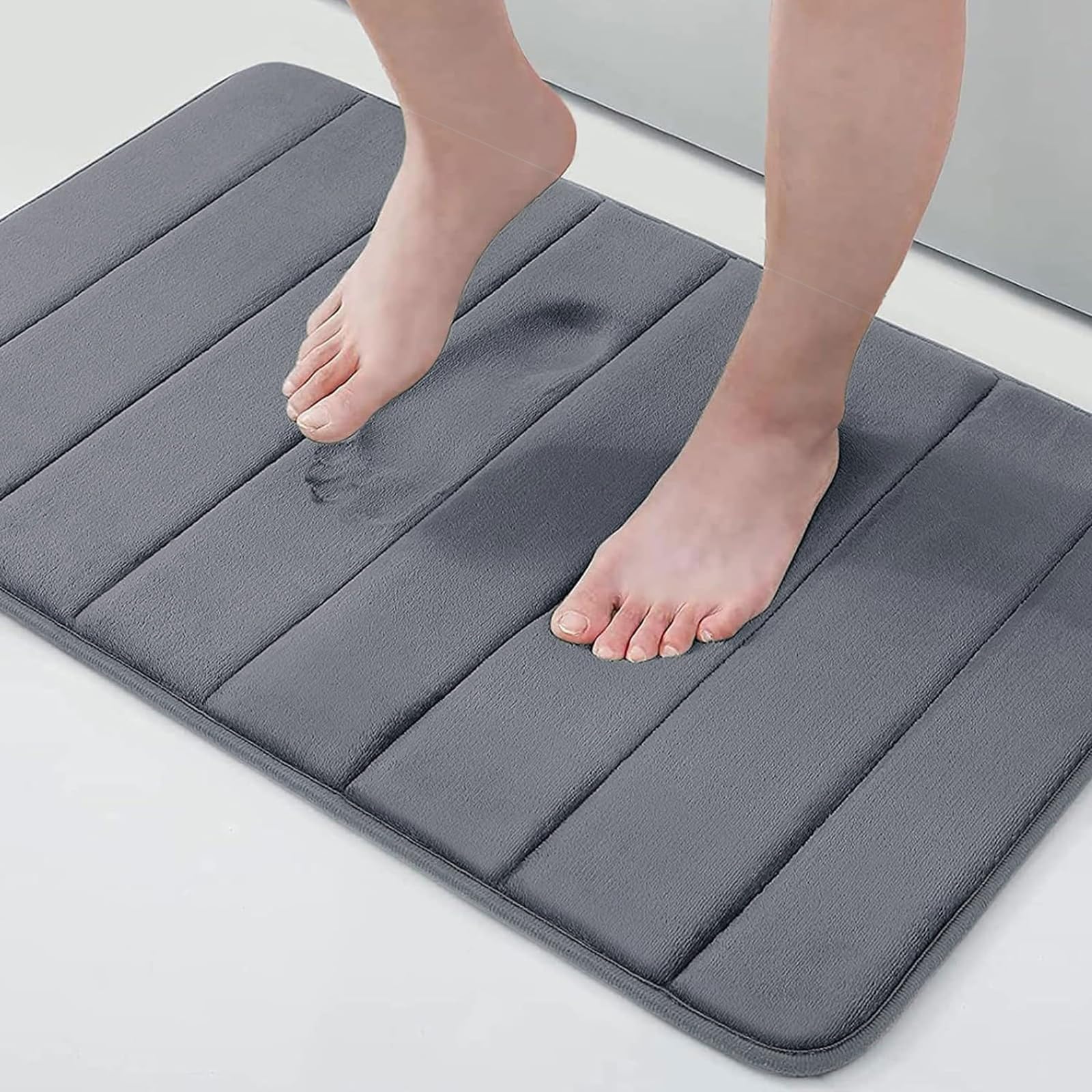 Buganda memory foam bath mat with plush velvet surface for soft, cushiony feet.