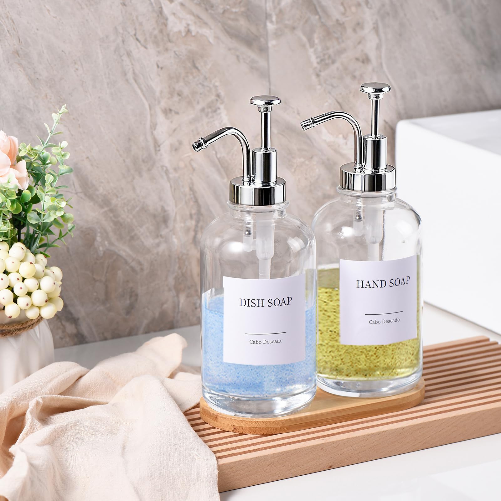 Two-pack Cabo Deseado glass dispensers with pumps keep your sink organized.