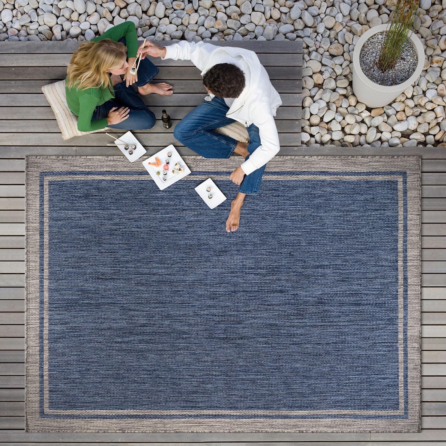 CAMILSON bordered navy rug complements garden and balcony spaces.
