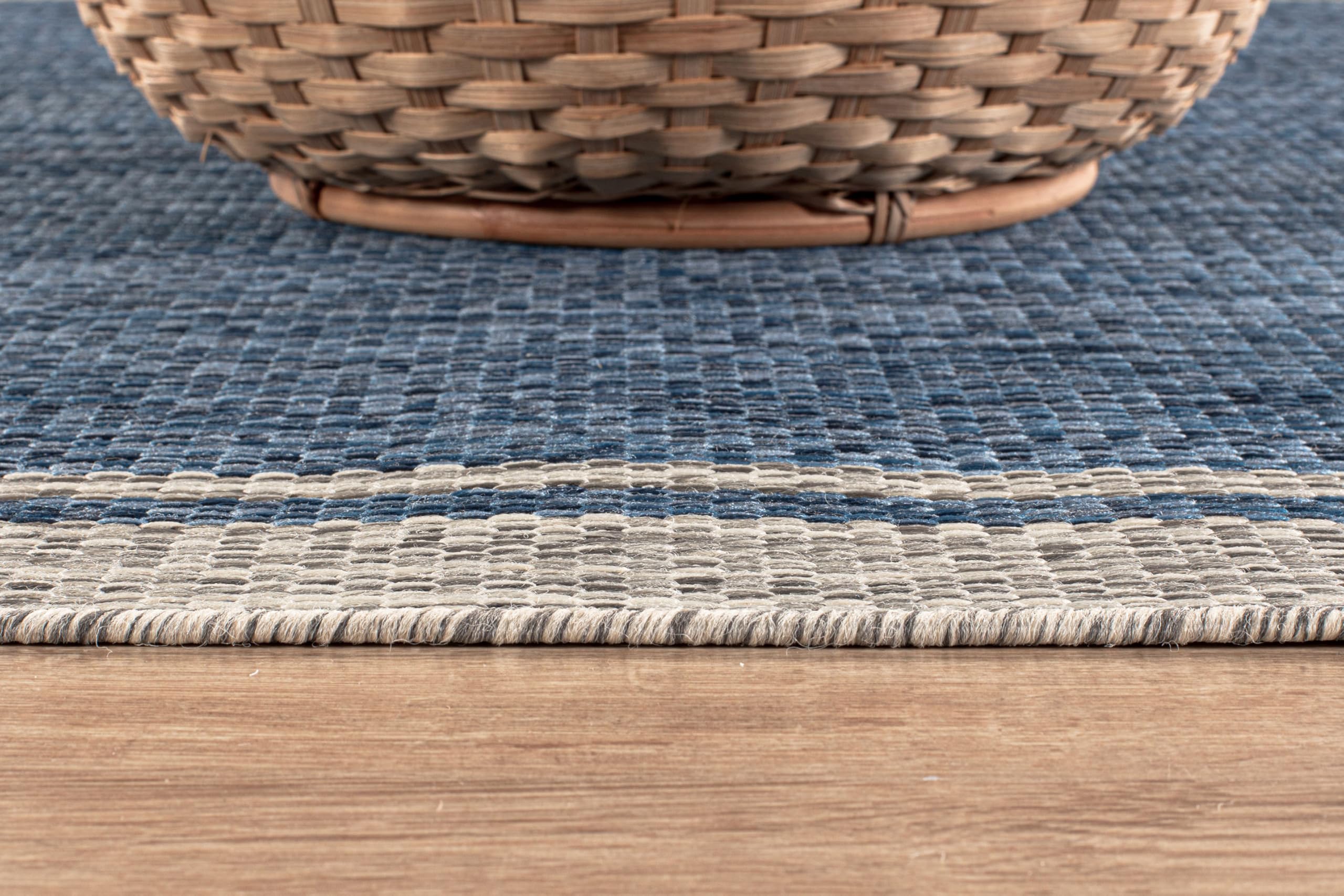 CAMILSON indoor-outdoor rug supports kitchen and living room setups.