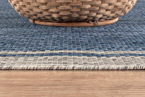 CAMILSON indoor-outdoor rug supports kitchen and living room setups.