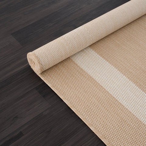 CAMILSON rug rolled on deck, lightweight and portable.