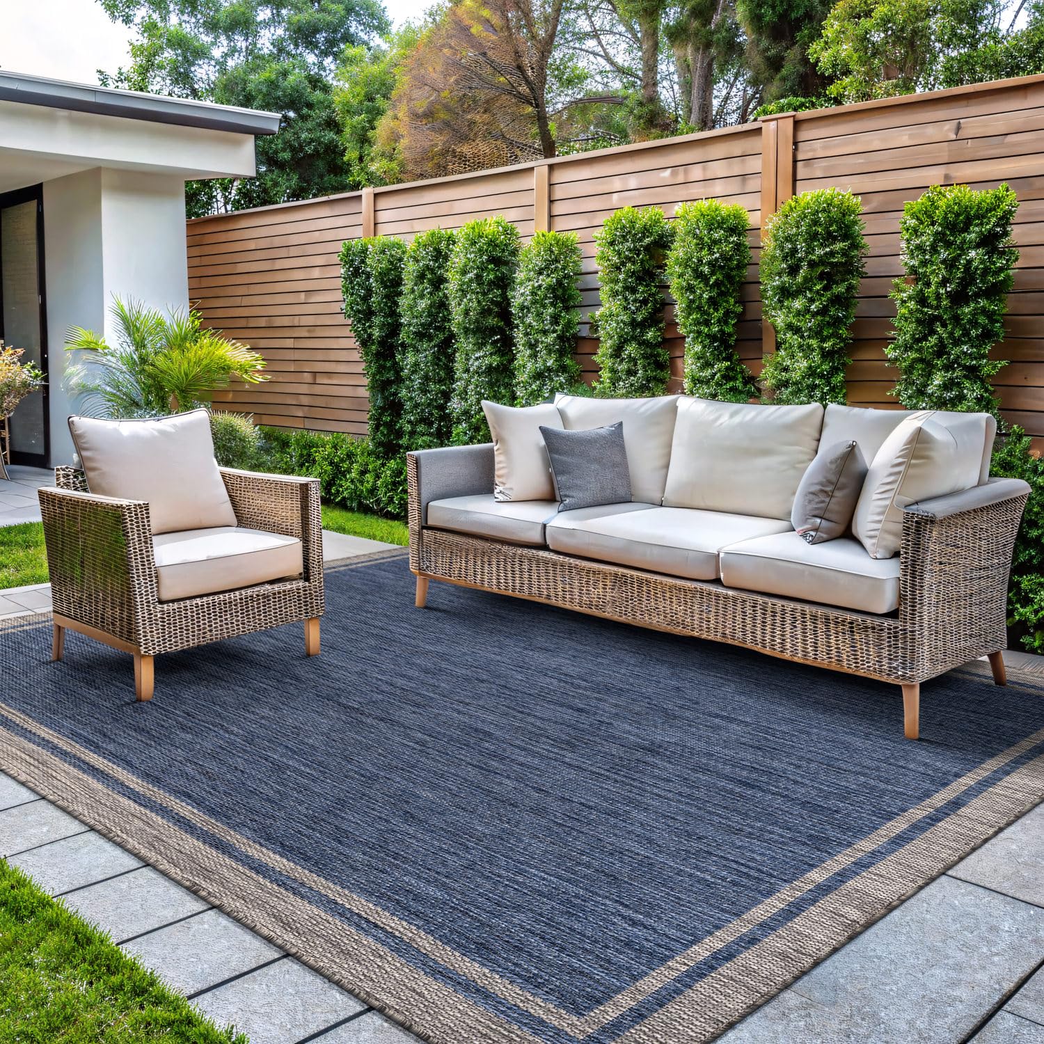 CAMILSON outdoor rug bordered navy 5x7 on patio, durable for indoor and outdoor use.