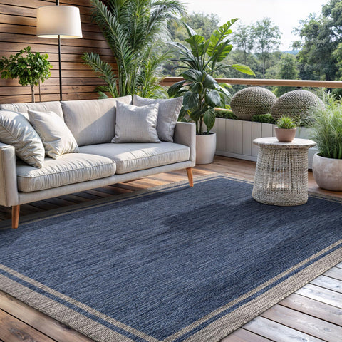 CAMILSON navy-bordered rug on a deck ready for quick vacuuming.