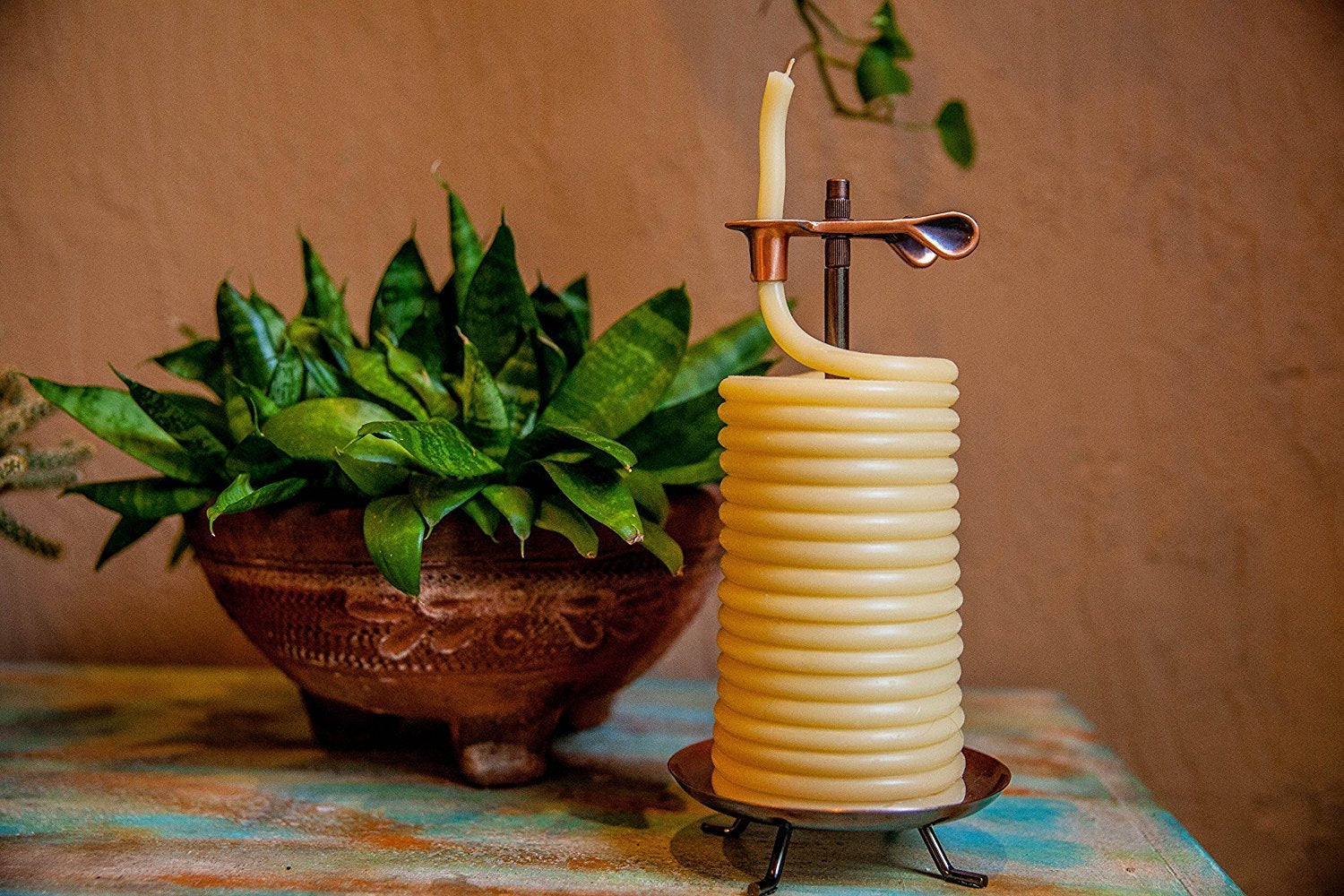 Candle by the Hour vertical coil fed through spring-loaded clip showing adjustable burn increments