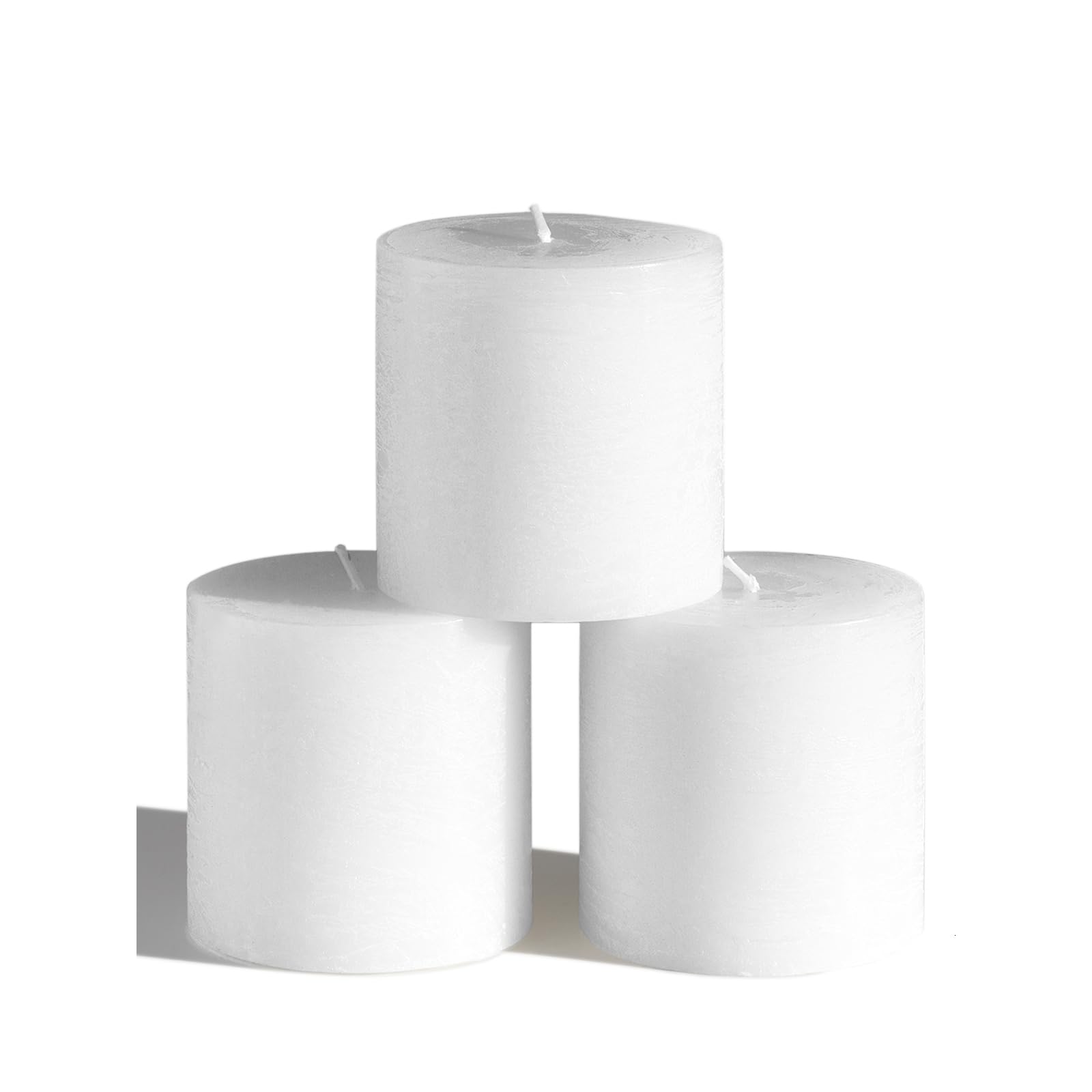 CANDWAX 3x3 pillar candles on a tablecape deliver warm, steady light.