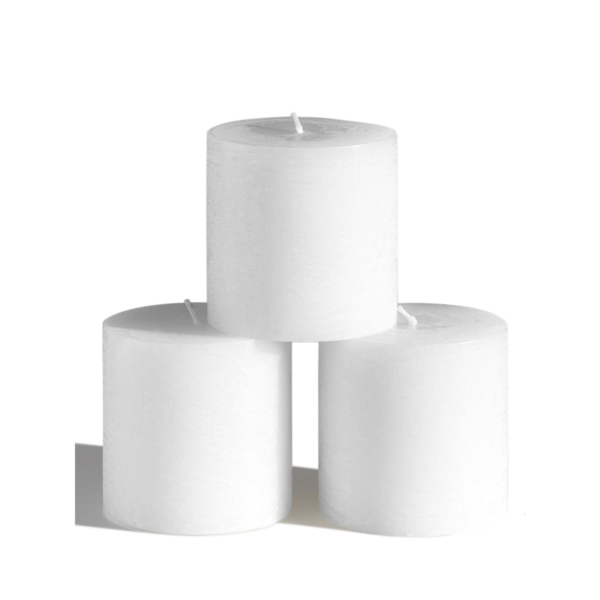 CANDWAX 3x3 pillar candles on a tablecape deliver warm, steady light.