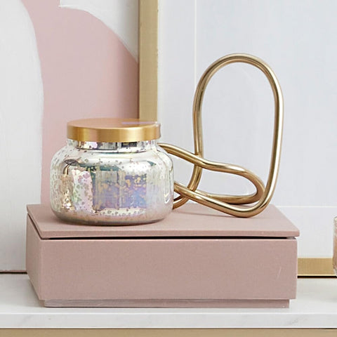 Capri Blue decorative candle on a stylish living room shelf.