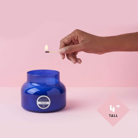 Capri Blue Volcano candle lit in room creates warm tropical ambiance.
