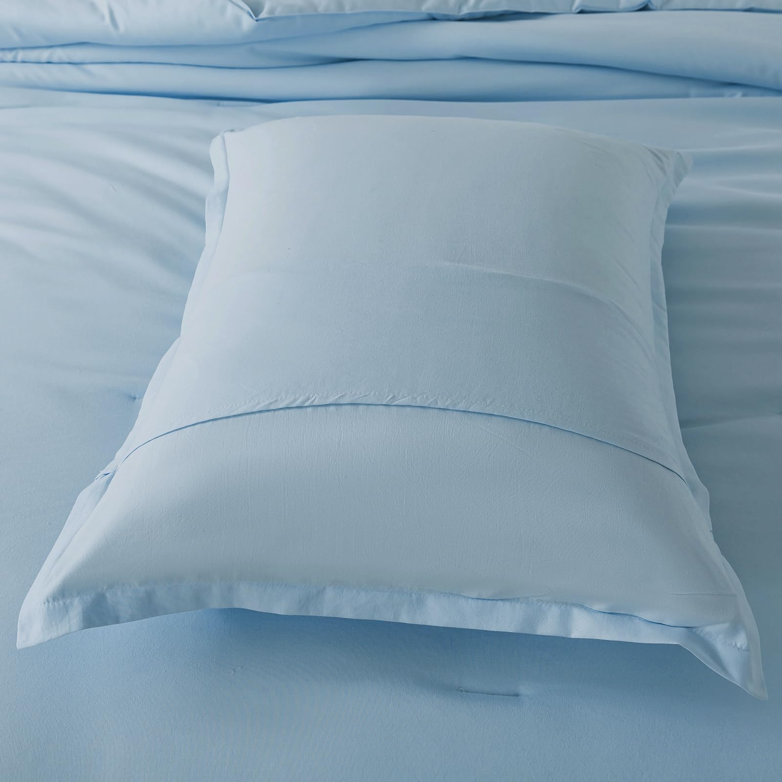 Caressma light blue comforter shown in a stylish bedroom setup for everyday use