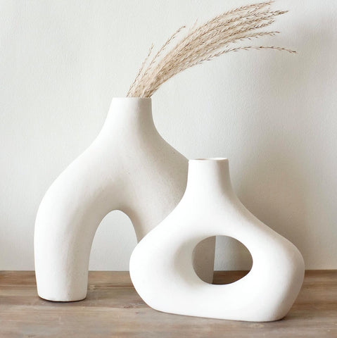Carrot's Den vases on a living room shelf evoke calm elegance.