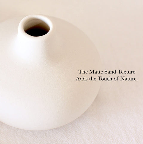 Durable ceramic with a clean white glaze suits minimalist interiors.